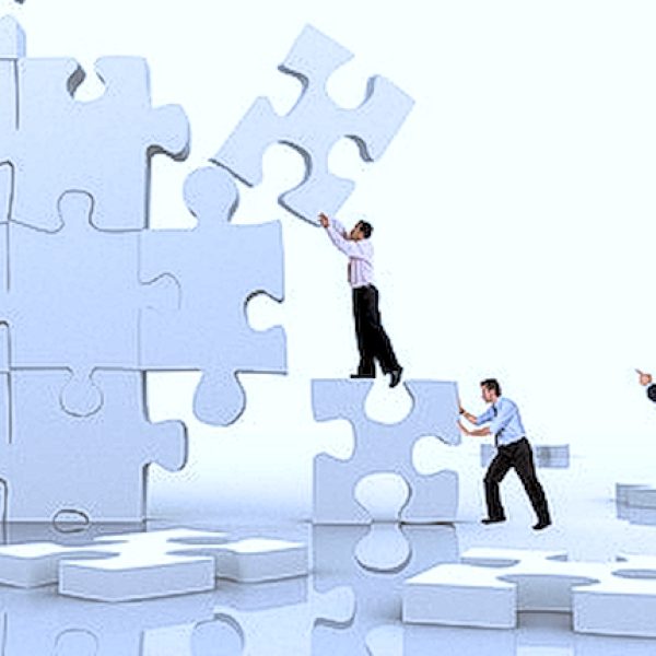 business team work building a puzzle isolated over a white background